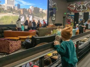 child in new parkway movie theatre with couches and big chairs.