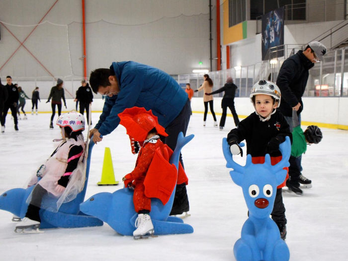 children skating with parents and props