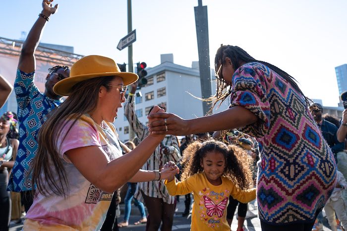 three people dancing at Black Joy Parade Oakland