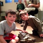 kids at sulphur creek with a turtle