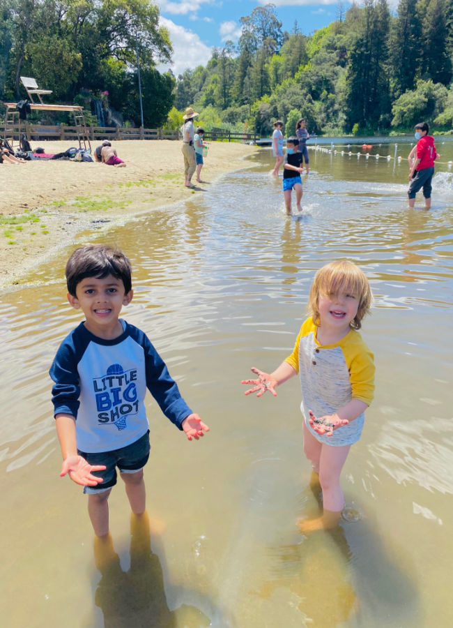 two children splash in Lake Temescal