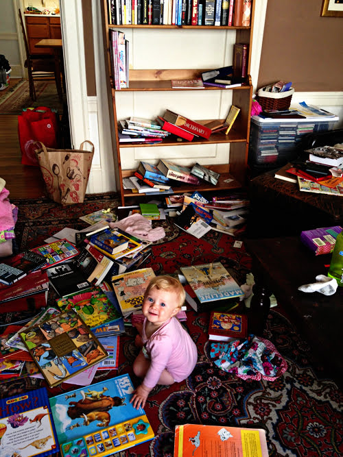 baby surrounded by books