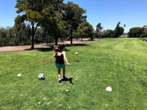 kid tees off at FootGolf