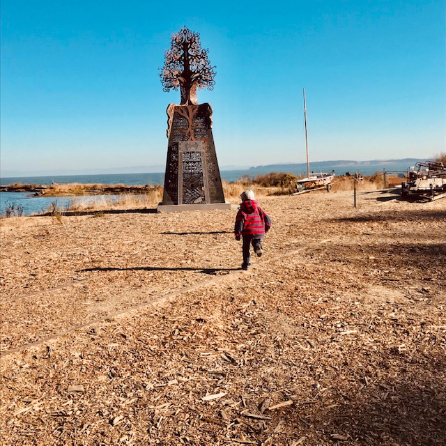 Sea Glass Treasure, A Pirate Ship & Burning Man Art in Richmond 6 child running towards tree statue