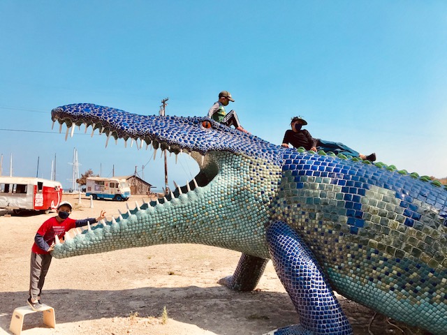 Sea Glass Treasure, A Pirate Ship & Burning Man Art in Richmond 3 kids climbing on crocodile statue