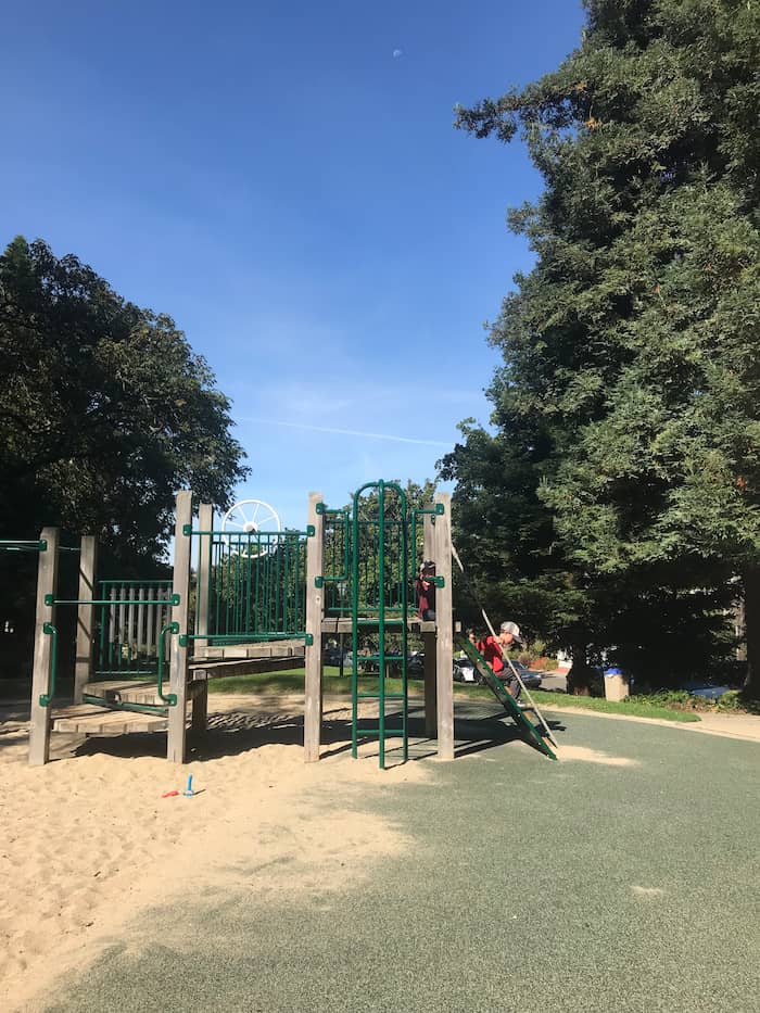child playing on play structure
