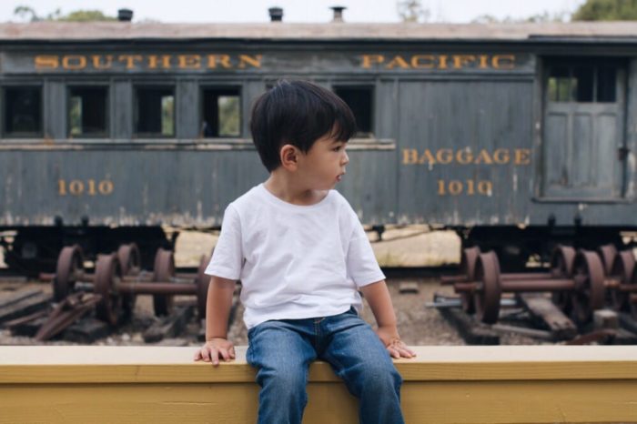 child in front of train