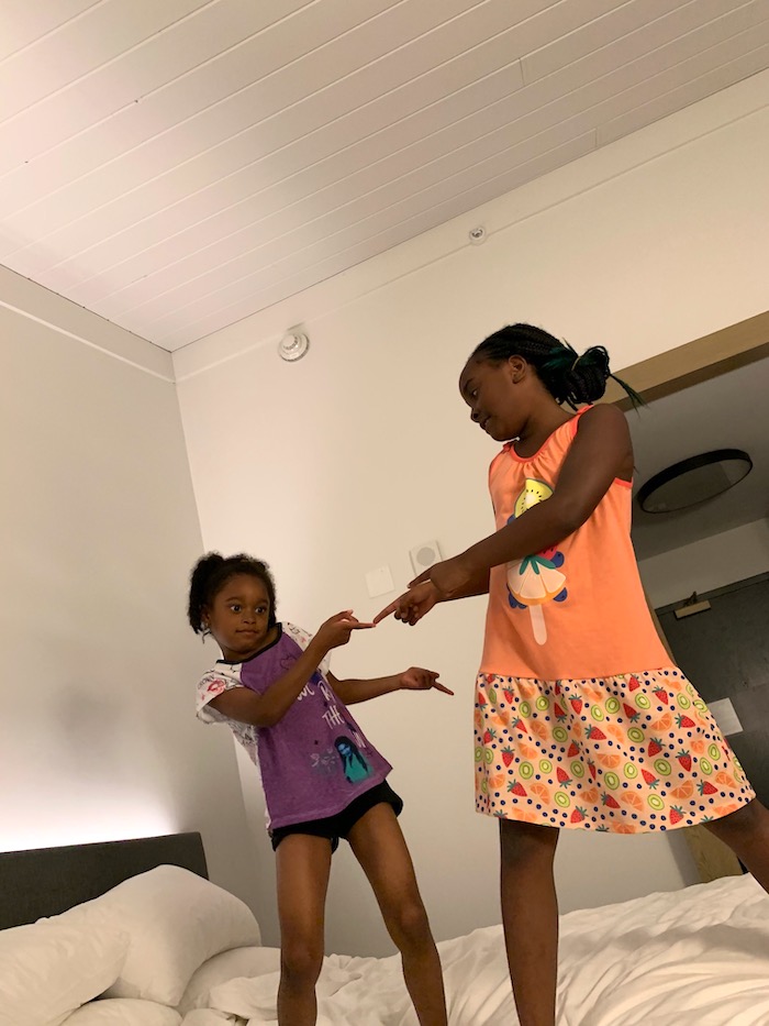 Kids jumping on the hotel bed