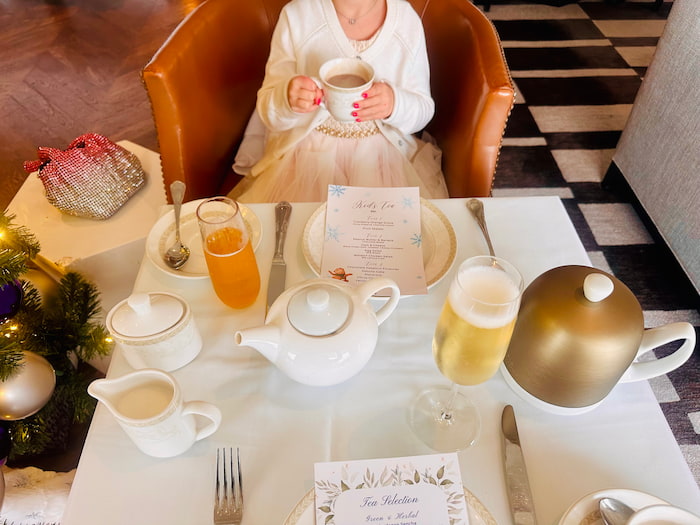 holiday tea table with little girl drinking tea