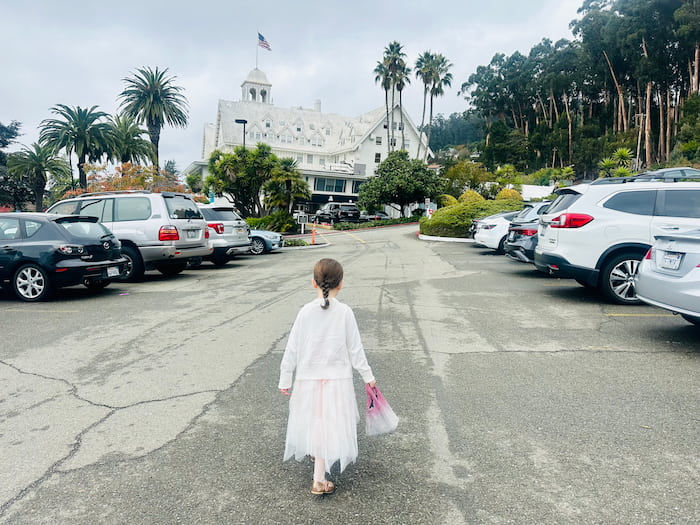 little girl walking towards Claremont hotel