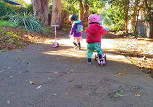 kids on scooters on a trail near frog park