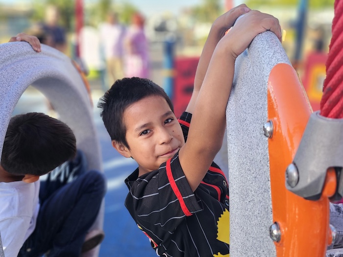 child climbs on structure on school playground