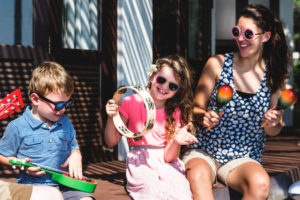 Family playing music together on porche