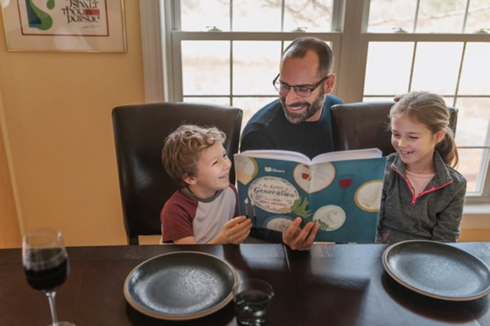 dad reading to kids from jewish books