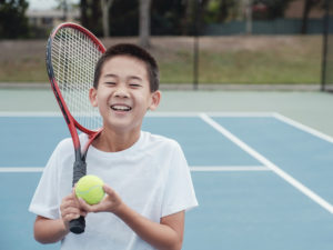tennis playing kid