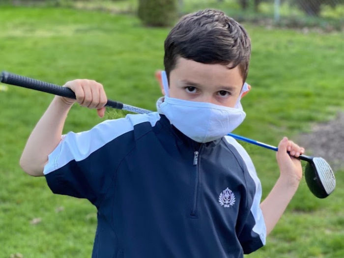 Youth on Course: Kids Play Golf for $5 or Less 3 Child golfs in a mask