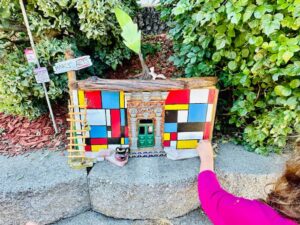 little kid hand opening fairy house door