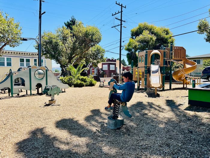 boy playing on bouncy playground toy