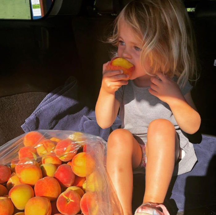 child eating peaches