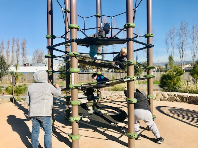 children climbing rope structure