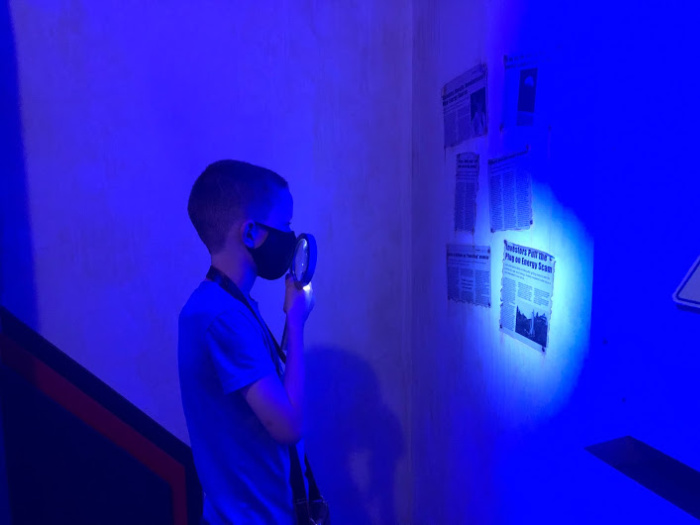 Kid looks for clues in escape room