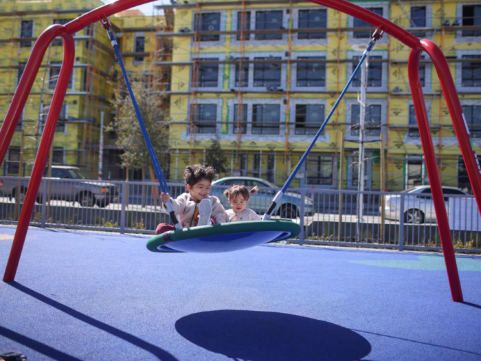 two kids on a big swing