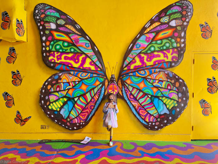 Visiting iconic murals in San Francisco's Umbrella Alley. | Photo: Julia Gidwani
