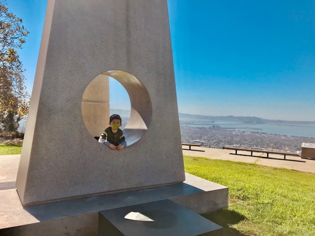 child outside on sun stone