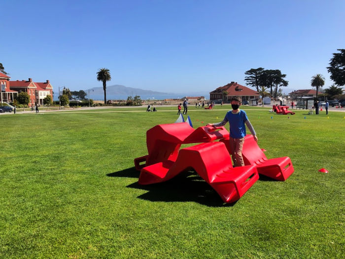 boy lawn giant red chairs