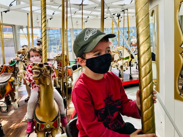 kids riding carousel