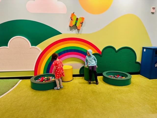 kids playing by rainbow wall