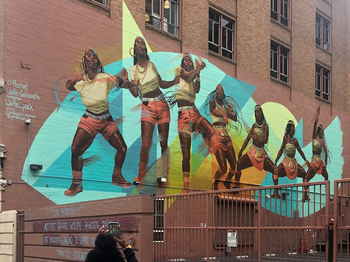 wall mural of a woman dancing through time in oakland