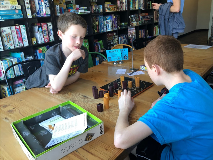 two kids play board games