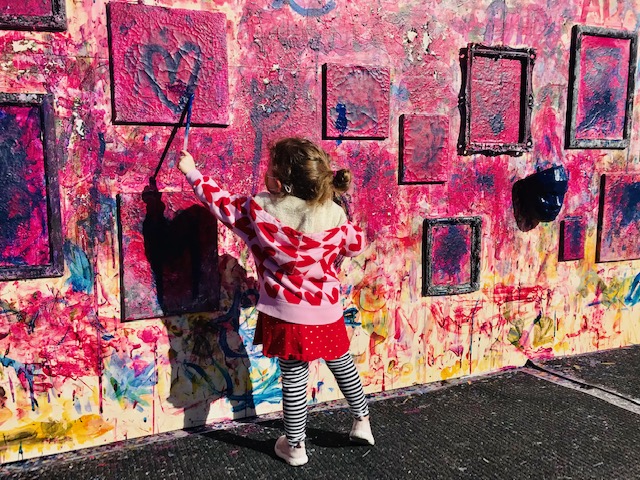 child painting picture on wall