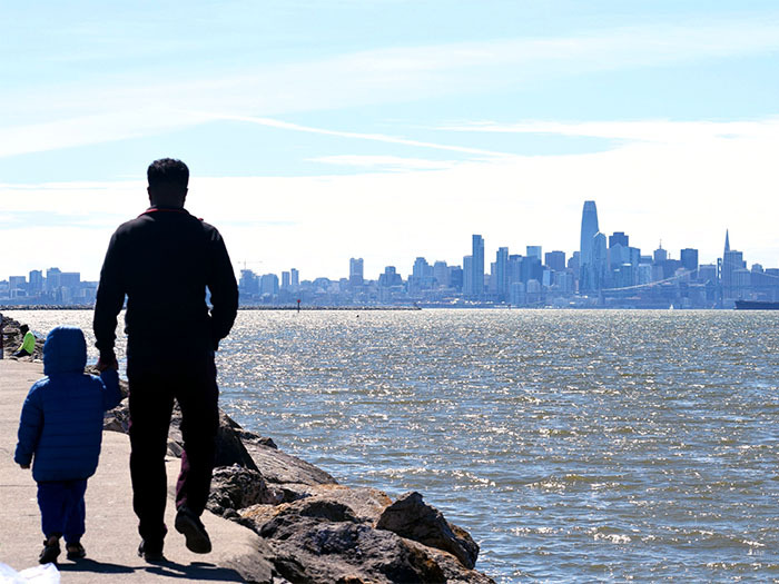 Father and child walk along SF Bay waterfront trail