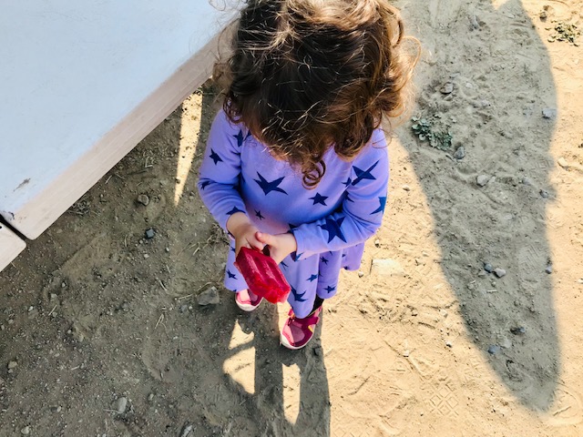 little girl eating popsicle