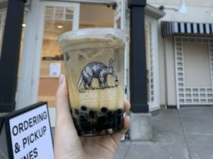 Person holding a boba tea outside of Boba Guys in Oakland