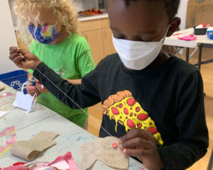 two young art students sewing felt