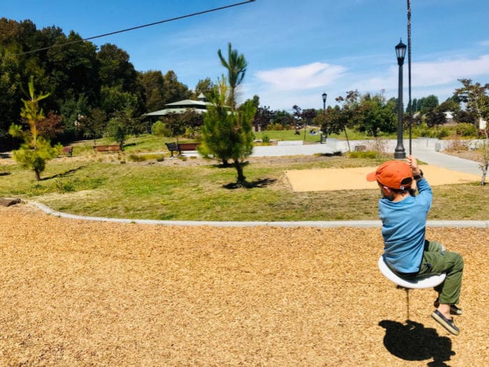 child on zip line at playground