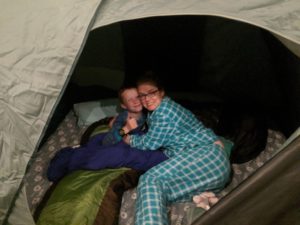 Mother and son camping in a tent