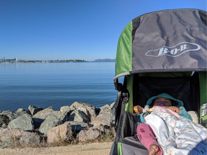 baby in stroller in front of waterfront in Emeryville