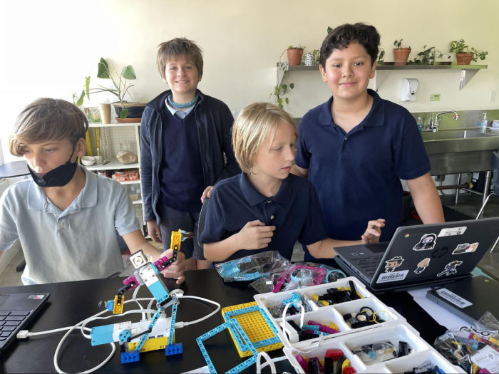 sixth graders in a robotics class with various parts