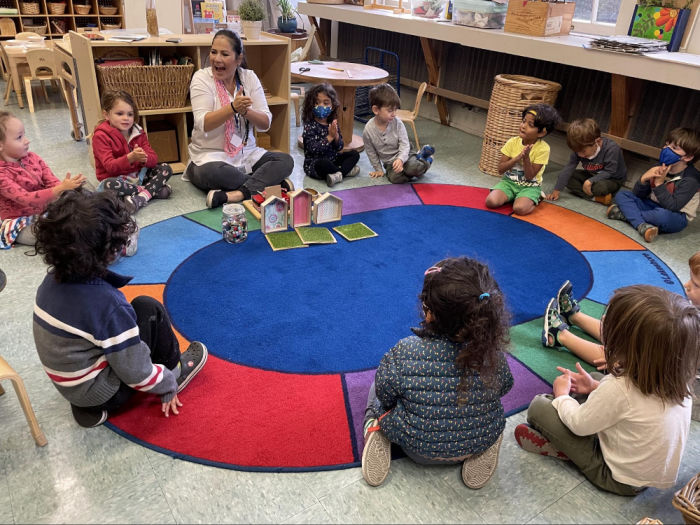 Spotlight on EBI, PK-8th International Education 2 four year olds at circle time on a rug