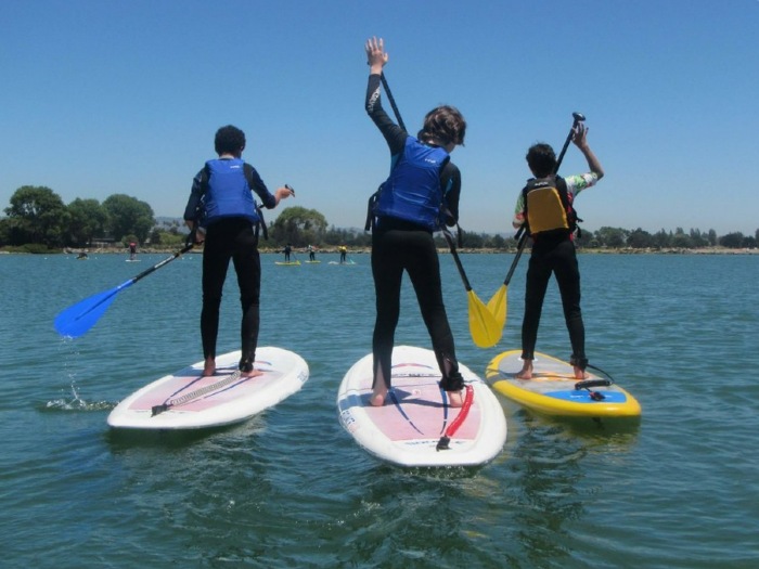 Teens stand-up paddleboarding at Mike's Paddle in Alameda