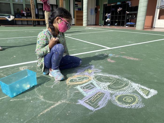 Sponsor Spotlight: Black Pine Circle School 1 chalk art and small child