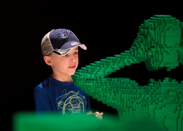 child with LEGO sculpture