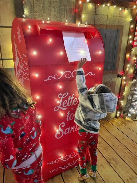 santa mailbox in sacramento with child on tiptoes