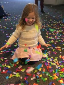 Child plays with confetti