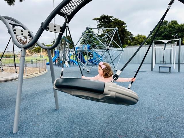 child swinging on disc swing