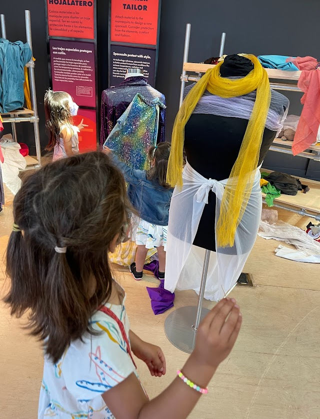 child designing a space suit from scarves
